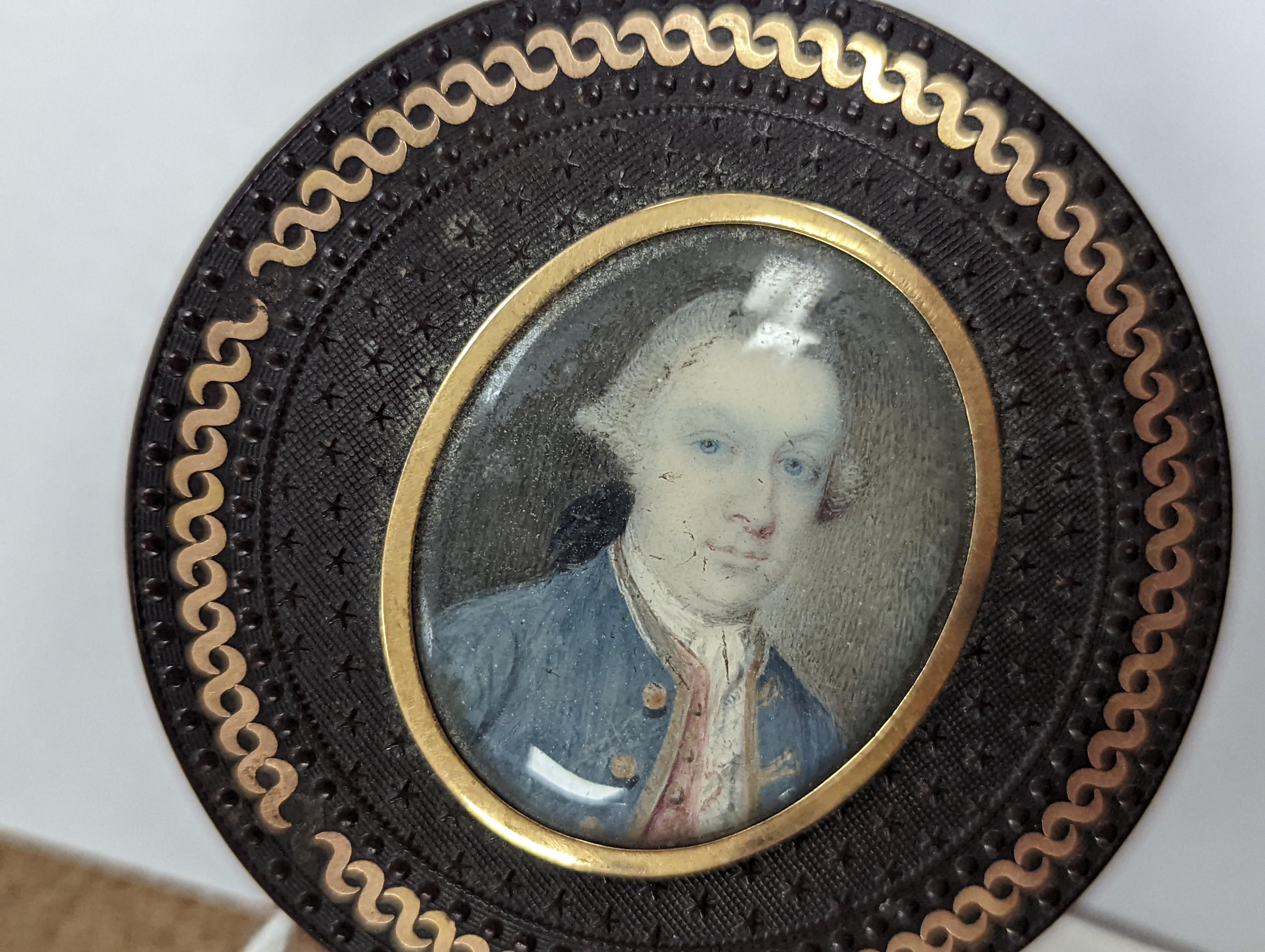 A 19th century pressed bois durci and gilt metal snuff box with painted miniature portrait of a gentleman on ivory to cover. 6cm diameter